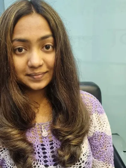A gorgeous global hair color with highlights. The warm brown and blonde tones blend together perfectly, and the soft curls at the end complete the look.