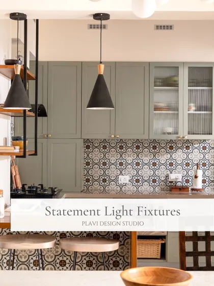 Statement lighting fixtures, like these black and wood pendants over the breakfast bar, can elevate a kitchen's design and define different zones within the space.