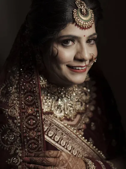 A warm and inviting portrait of a bride, her smile reaching her eyes. The soft lighting is flattering and creates a classic look.