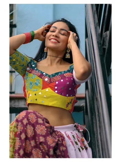 A joyful and vibrant portrait of a woman in colorful traditional attire. This image captures a feeling of celebration and happiness.