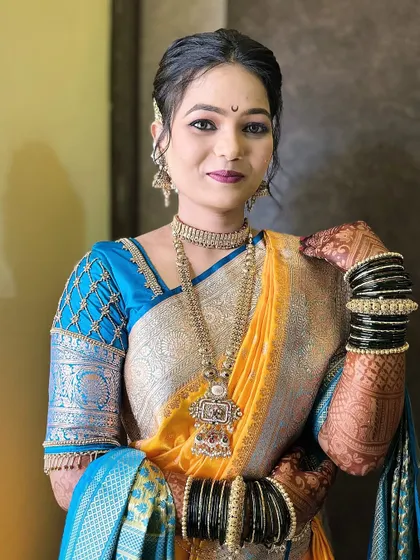 A close-up portrait of the bride, showcasing her intricate jewellery and the subtle makeup that enhances her features.