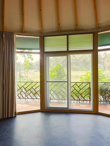 The large bay windows of our riverside cottage offer panoramic views of the natural landscape.