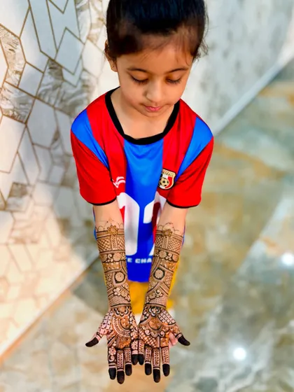 Even the little ones can join in. Here is a full, detailed mehendi design for a 6-year-old, personalized with her brother's name, "Zohan."