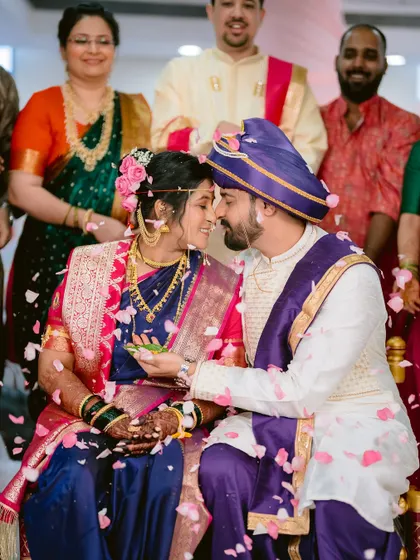 An intimate moment during the wedding ceremony, with petals showering the couple.