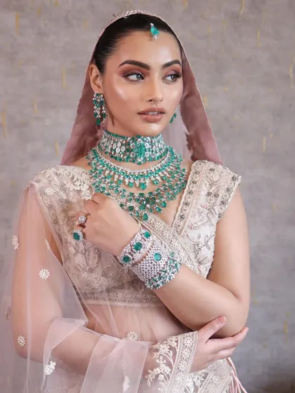 This look is all about ethereal glow. We focus on skin preparation and layering highlighters to achieve this radiant, almost wet-look skin, paired with soft emerald tones on the eyes.