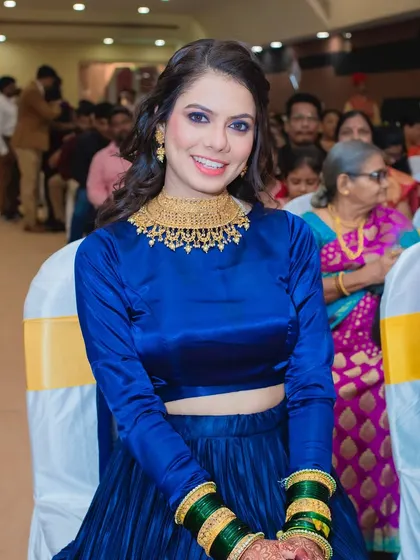 A happy bride enjoying her Sangeet. The makeup is vibrant and fun, perfect for the festive atmosphere.