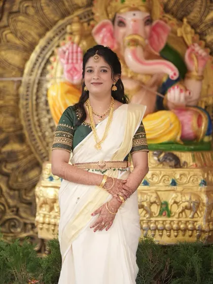 Another shot of Sneha's Varapooje look, showing how the makeup complements the traditional attire and setting.