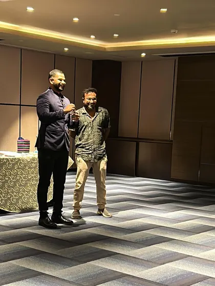 Sharing a laugh with a volunteer on stage during a smaller corporate gathering. Building rapport and making people feel comfortable is essential to my interactive style.