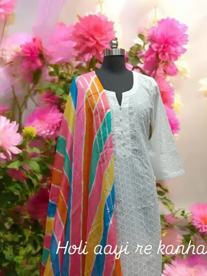 "Holi aayi re kanhai..." This image captures the spirit of Holi with a classic white chikankari kurta paired with a vibrant, multi-colored leheriya dupatta.