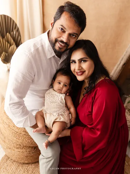 A bright and happy lifestyle family portrait. The family's smiles and the warm, earthy tones of the boho set create a joyful and welcoming image.