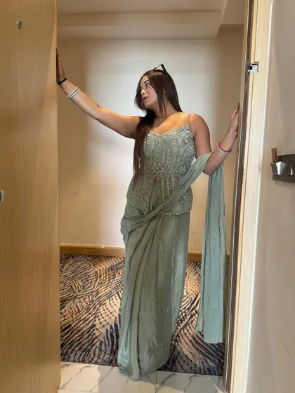 Another look at this elegant sage green ensemble. The intricate beadwork and flowing fabric make it a standout piece for any wedding event.