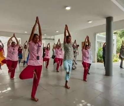 A yoga session taking place in one of the open, sheltered common areas at KIPCER, demonstrating the flexible use of these spaces.