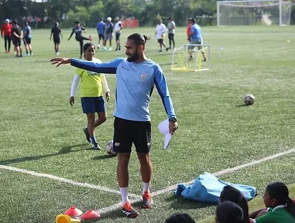 Our on-field coaching is practical and direct. This image from the FIFA Women's Development Programme shows our coach providing real-time instruction to players during a strength and conditioning drill.