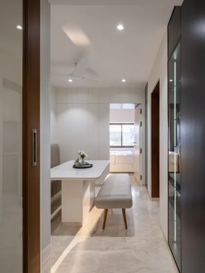 The clean lines of the dining table and benches ensure the walkway remains unobstructed, a key consideration in our space-saving design approach.