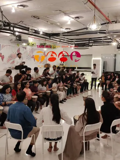 A full view of a drum circle in a modern co-working space. It demonstrates how we can transform any environment into a space for creativity, focus, and team connection.