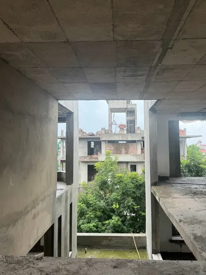 A view from within The Nest during construction, looking out through the concrete frame. This perspective shows how we design openings and volumes to frame views and create a sense of layered space, even in the building's raw state.