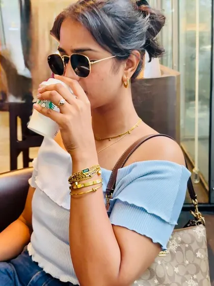 This photo captures a natural moment, showing how the jewellery pieces complement a casual outfit. It's a great example of subtle product placement in a lifestyle context.