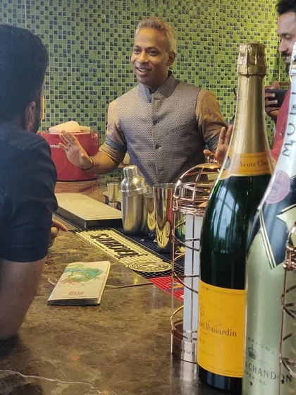Engaging with guests is at the heart of what I do. Here, I'm discussing champagne options and cocktail preferences at a private party, ensuring everyone feels welcomed and gets a drink they truly enjoy.