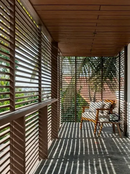 The western side of the house is lined with louvered screens that provide shading from the harsh sun while creating beautiful patterns of light and shadow.