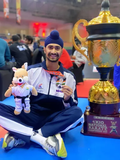 Celebrating the team's success at the 4th KIO National Karate Championship with the trophy. Individual medals are great, but team trophies represent collective strength.
