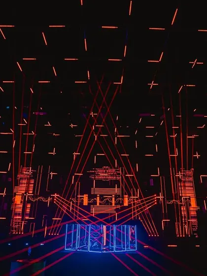 The main stage and DJ booth, featuring a massive grid of programmed laser lights and strobes. The light show was synchronized with the music to create an authentic techno club experience.
