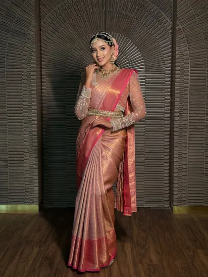 A classic portrait of the bride in her pink Kanchivaram. The drape is elegant and timeless, perfect for creating lasting memories.