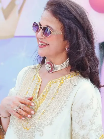 An elegant guest at the birthday party, looking stylish in her traditional attire and sunglasses. I capture the style of the guests as well as the kids.