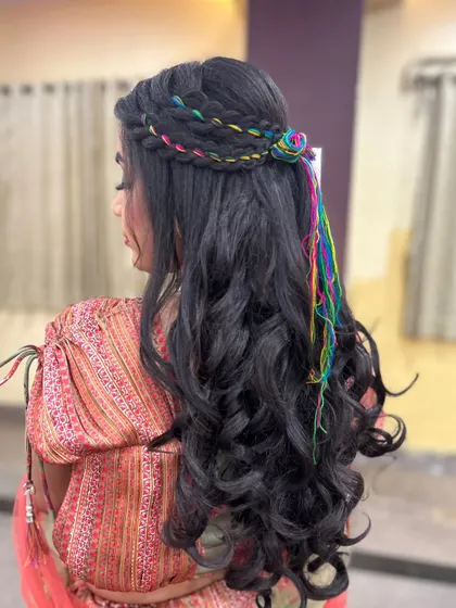 A full view of the hairstyle, showing how the crimped texture and colorful braids create a fun and unique look for the Mehendi function.