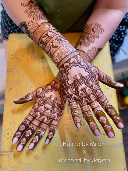 Another view of the jhula-themed bridal mehendi, this time with a nature-inspired tree design on the other arm.