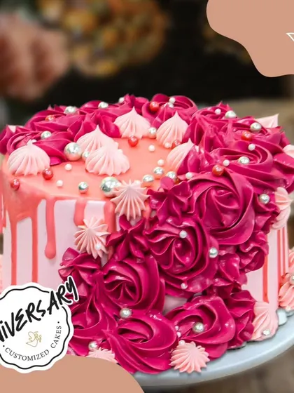 Dripping with love for Mr. and Mrs. Chauhan's anniversary in Punjabi Bagh. This vibrant pink cake features a cascade of deep red buttercream roses and delicate drip details.