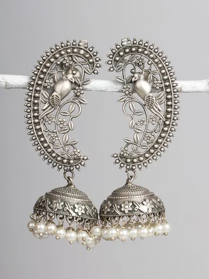 These stunning oxidized silver ear cuffs feature a bird motif and a large jhumka with pearl details. A true statement piece for any jewellery lover.