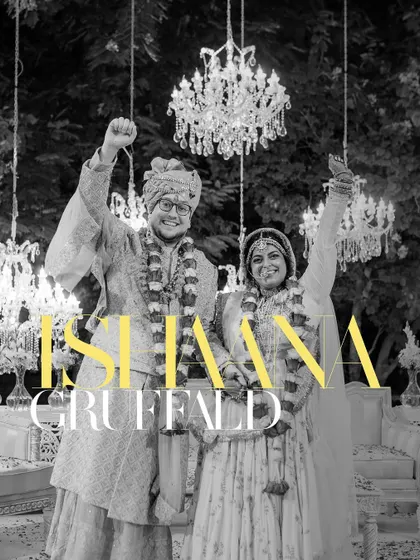 A celebratory black and white portrait of Ishaana and Gruffald. This timeless style emphasizes their joyful expressions and the grand chandelier, adding a touch of vintage elegance to their Jaipur wedding.