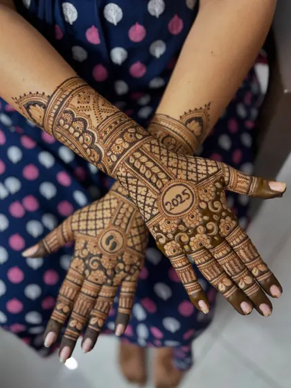 A top-down view of the baby shower mehendi, showing the complete design across both hands.