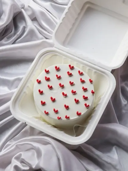 A cute bento cake covered in tiny red hearts. It's a simple way to say 'I love you'.
