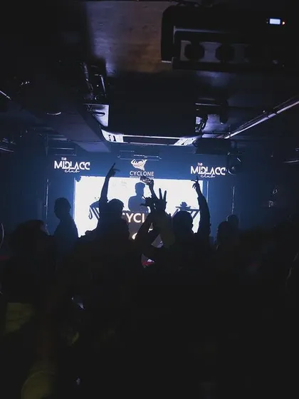 A darker shot of the crowd at Cyclone, lost in the music.