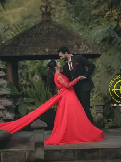 A romantic pre-wedding scene in a Bali-themed garden. The red trail gown adds a splash of vibrant colour and passion to the intimate moment.