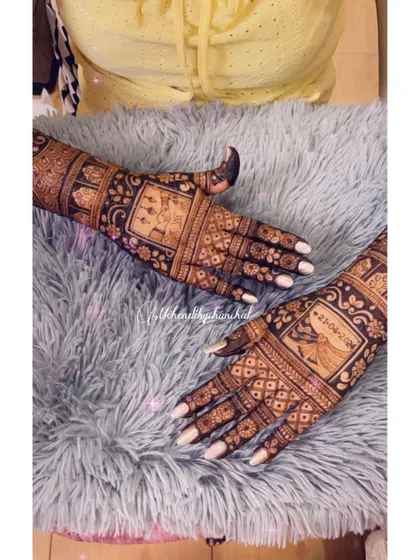 A close-up of the back of the hands, showing the continuation of the wedding story with more figures and traditional patterns.