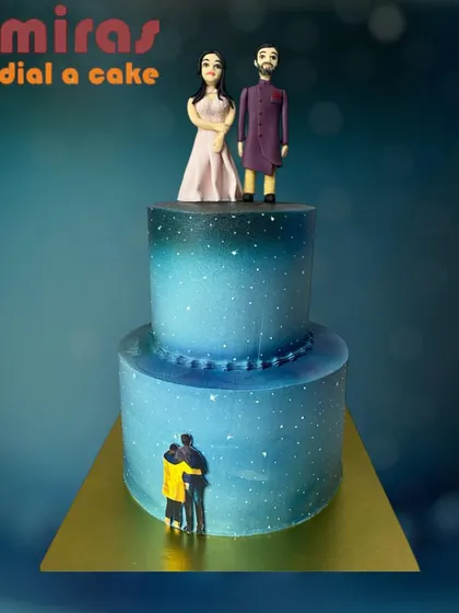 A dreamy, starry night-themed wedding cake. This two-tier blue ombre cake is decorated with tiny stars and features figurines of the couple, creating a romantic and celestial vibe.