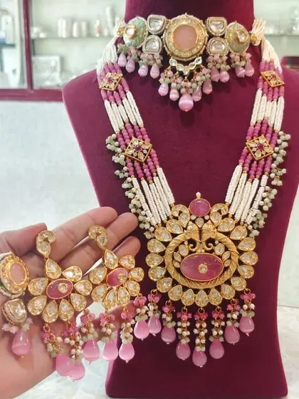 A grand bridal set in pink and white, featuring a choker and a long rani haar. This is a complete rental set with matching oversized earrings.