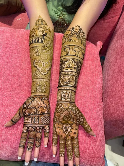 A beautiful example of a full bridal set with a mix of different patterns. One arm features traditional Rajasthani motifs, while the other has more geometric Madhubani-style work.