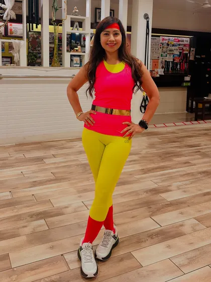 Here I am, dressed and ready for our 80s Aerobic Workshop. The bright neon colors, headband, and leg warmers were all part of the fun, helping everyone get into the spirit of the high-energy, retro-themed workout.