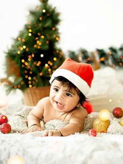 A happy baby enjoying tummy time amidst our Christmas decor. We ensure our themed sets are safe and comfortable for even the littlest clients.
