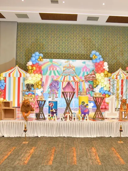 The full stage for the carnival party, showing the wide backdrop and numerous themed props.