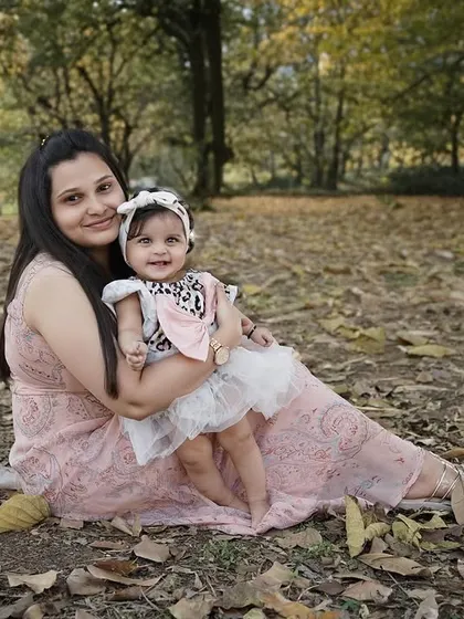 An outdoor session with mom and baby, sitting among the autumn leaves. Nature provides a beautiful, rustic backdrop for family portraits.