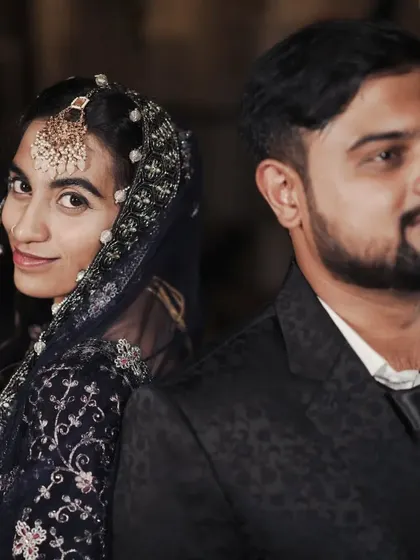 A stylish portrait of a Muslim couple at their reception. The bride's glance over her shoulder adds a touch of elegance and personality.