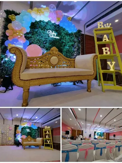 I create complete themed decor for baby showers, like this pink and blue setup. You can rent everything you see here, from the ornate golden sofa and green wall backdrop to the "BABY" marquee letters and matching chair covers for guests.