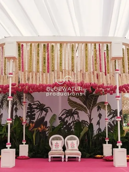 A wide view of the Haldi stage, showing the guest seating and food stations in the background.