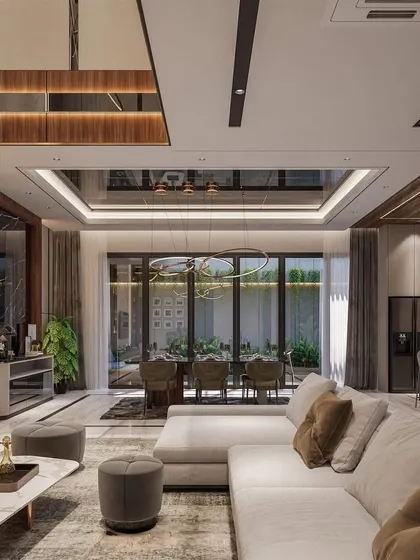 This render showcases a spacious living area with a large sectional sofa, a statement coffee table, and a reflective ceiling that enhances the sense of space. The design is focused on creating a luxurious and comfortable family area.