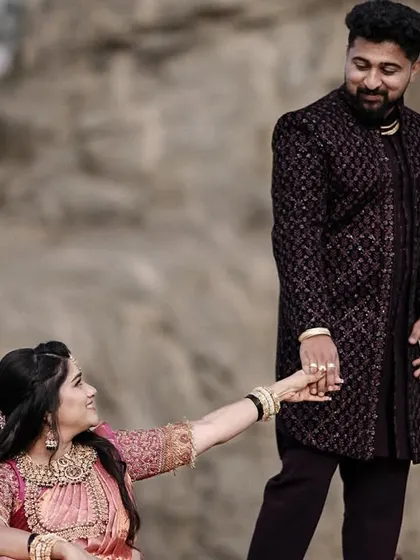 A playful take from the rocky landscape shoot, with the bride reaching for the groom's hand. It adds a touch of storytelling to the portrait.