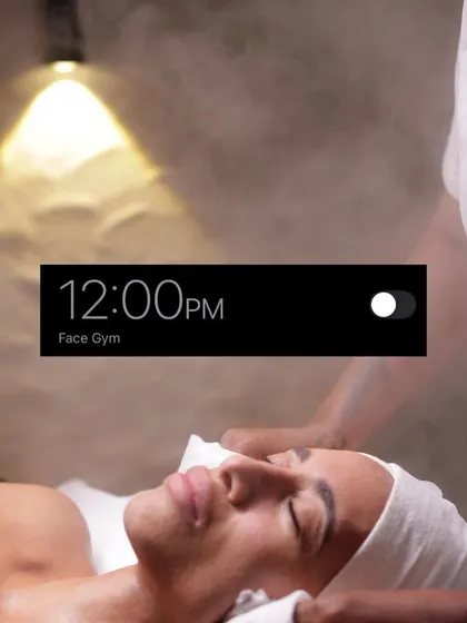 It's 12:00 PM, time for your Face Gym appointment. This image captures a client enjoying a moment of pure relaxation while our therapist works to tone and sculpt her skin.